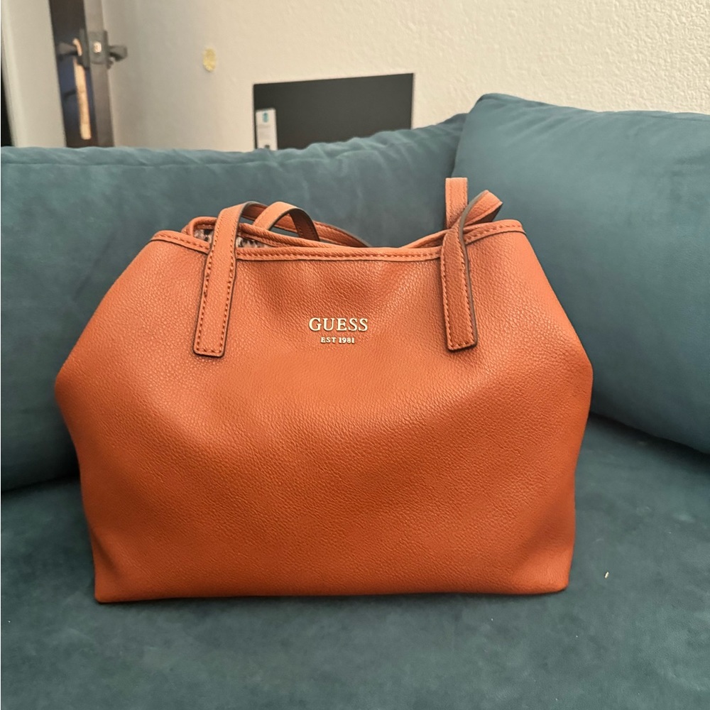 Guess cognac and black satchel purse.